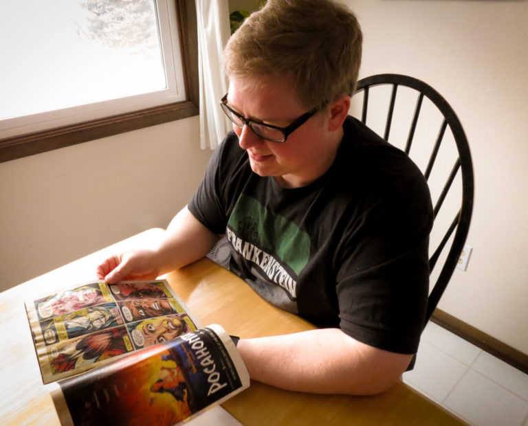 Beau Batterson reading the comic book that taught him how to draw.